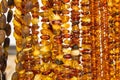 Shiny womanly amber necklaces on stall at the bazaar