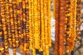 Shiny womanly amber necklaces on stall at the bazaar