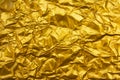 Shiny wrinkled gold foil texture background