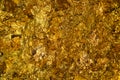 Shiny yellow gold leaf or scraps of gold foil background texture Royalty Free Stock Photo