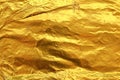 Shiny yellow leaf dark gold foil texture background Royalty Free Stock Photo