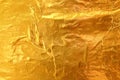 Shiny yellow leaf dark gold foil texture background Royalty Free Stock Photo