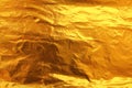 Shiny yellow leaf dark gold foil texture background Royalty Free Stock Photo