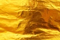 Shiny yellow leaf dark gold foil texture background Royalty Free Stock Photo