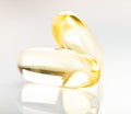Shiny yellow vitamin e fish oil capsule Royalty Free Stock Photo