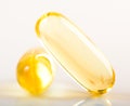 Shiny yellow vitamin e fish oil capsule Royalty Free Stock Photo