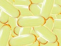 Shiny yellow vitamin omega3 fish oil capsule background. Royalty Free Stock Photo