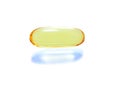 Shiny yellow vitamin omega3 fish oil capsule on white backgroun Royalty Free Stock Photo