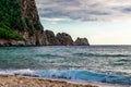 Ship against the backdrop of four rocks in the turquoise water of the Mediterranean Sea in Alanya Turkey. Seascape with waves Royalty Free Stock Photo