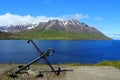 A ship anchor overlooking the mountain in the summer near Olafsfjordur, Iceland