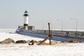 Ship anchor on shore along pier with lighthouse in Duluth, Minnesota Royalty Free Stock Photo