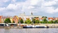 Ship anchored on Odra River embankment. Castle of Pomeranian Dukes in Szczecin in background