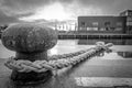 ship is attached with a thick rope to a bollard in the harbour Royalty Free Stock Photo