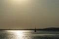 A ship on a background of a silver calm Black Sea at sunset. Royalty Free Stock Photo