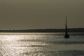 A ship on a background of a silver calm Black Sea at sunset. Royalty Free Stock Photo