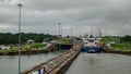 A ship being escorted into the Panama Canal by a pilot boat Royalty Free Stock Photo