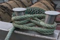 Ship bollard with ropes to which boat is moored