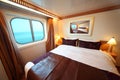 Ship cabin with bed and window with view on sea Royalty Free Stock Photo