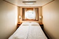 Ship Cabin With Bed And Window With View On Sea. Luxury Cabin On Ferry Boat Or Cruise Liner.