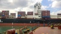 A ship with cargo containers on board. View of the cargo ship from the deck of the mooring site.