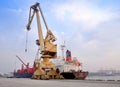The ship crane, loading discharging operation for transfer the cargo shipment in export and import, works by stevedore labor in Royalty Free Stock Photo