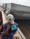 Ship crew wearing oxygen mask and preparing for entering the hatch for inspection