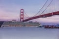 A crusie ship headed out to sea under the goldengate bridge