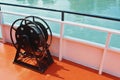 Ship details, black metal sailboat winch and a rope at the deck Royalty Free Stock Photo