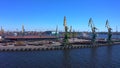 Ship docks off Kanonersky Island. Industrial port with water barges and transport tugs