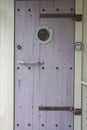 A ship door with a porthole Royalty Free Stock Photo