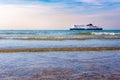 Ship ferry DFDS seaways. dramatic sky and blue water waves. surfer. Royalty Free Stock Photo