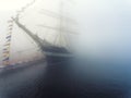 Ship with flags in the fog early morning Royalty Free Stock Photo