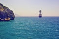 A ship floating in the sea and rocky shore Royalty Free Stock Photo