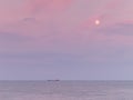 Ship on horizon at dusk Royalty Free Stock Photo