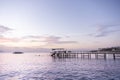 Ship on the horizon at sunset time at sea in pink and golden light Royalty Free Stock Photo