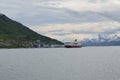 The ship hurtigruten entering tromsoe harbour in summer day with snowy mountain Royalty Free Stock Photo