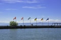 Ship landing stage on Lake Constance with a line of different national flags Royalty Free Stock Photo