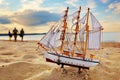 Ship model on summer beach at sunset Royalty Free Stock Photo