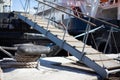 The ship is moored to a dock ladder rope chain