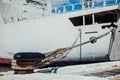 The ship is moored to a dock ladder rope chain