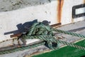 Ship mooring rope moored on the bollard. Moored boat in the port Royalty Free Stock Photo