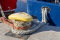 Ship mooring rope moored on the bollard. Moored boat in the port Royalty Free Stock Photo