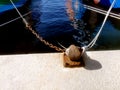 Ship mooring ropes secured around a port bollard Royalty Free Stock Photo