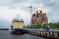 A ship near a pier of Arkhangelsk Severnaya Dvina river with a temple on background Royalty Free Stock Photo