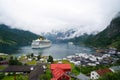 Ship in norwegian fjord on cloudy sky. Ocean liner in village harbor. Travel destination, tourism. Adventure, discovery Royalty Free Stock Photo