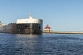 A Ship Passing A Lighthouse Royalty Free Stock Photo