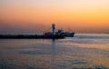 A ship passing a lighthouse in KadÃÂ±kÃÂ¶y Istanbul Royalty Free Stock Photo