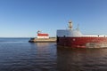 Ship Passing A Lighthouse On Lake Superior Royalty Free Stock Photo