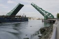 Ship Passing Under a Raised Green Drawbridge