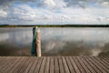 Ship pier with cloud reflection of a buoy and bollard with rope Royalty Free Stock Photo